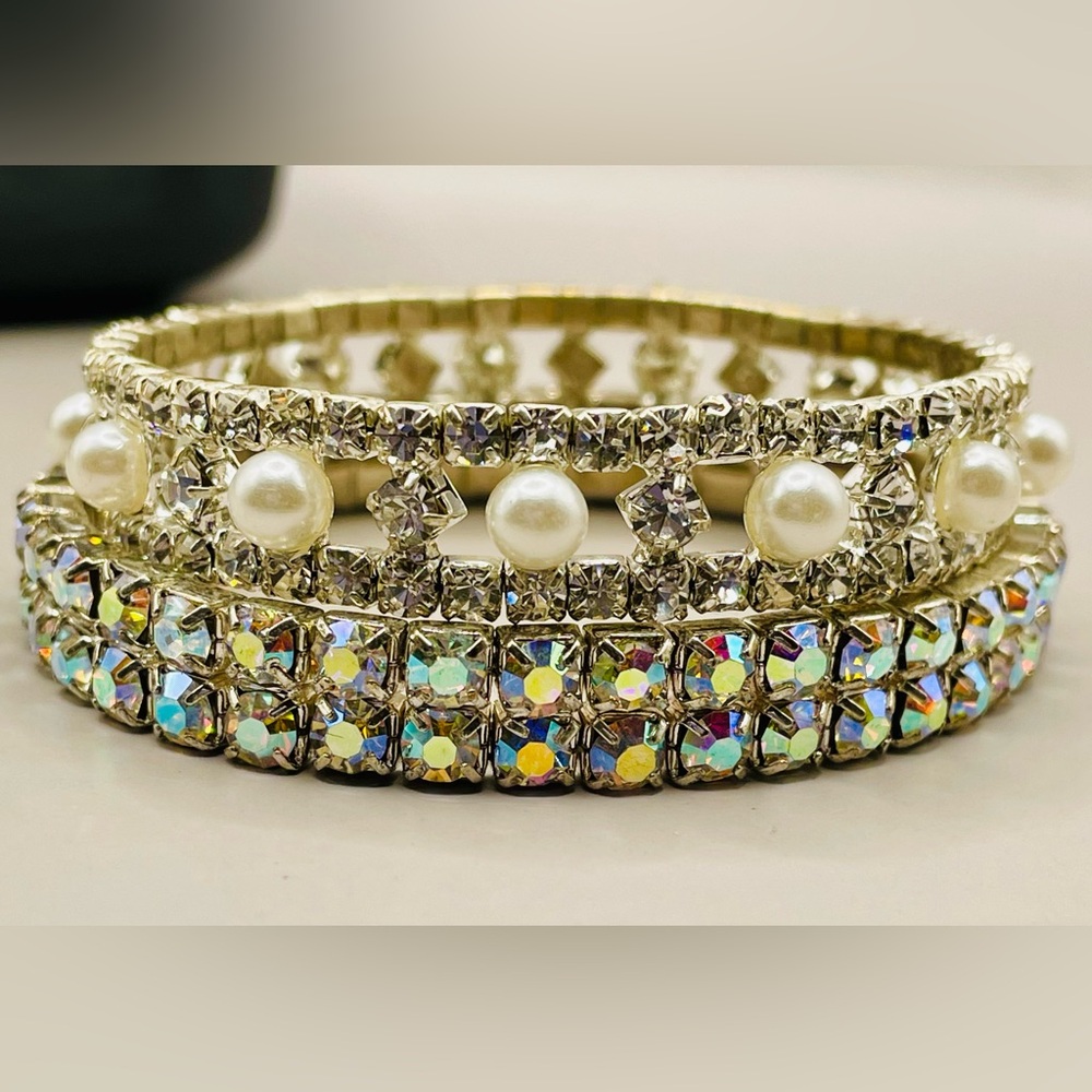 2 rhinestone stretch bracelets. One has aurora borealis gems. One has pearls